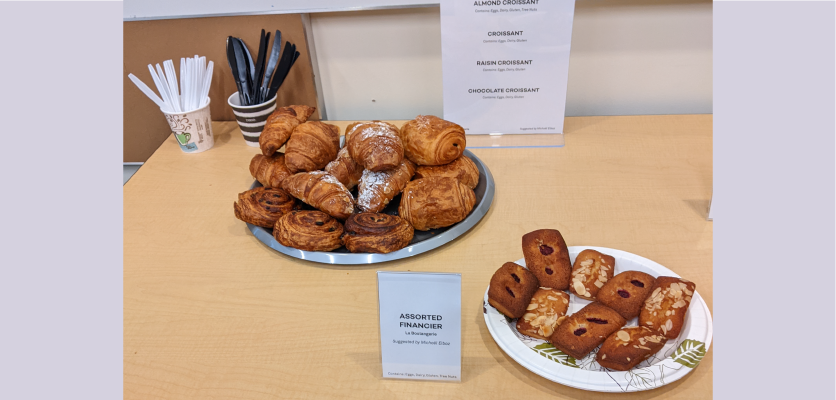 a plate of financiers in the foreground and a pile of assorted croissants on a plate in the background